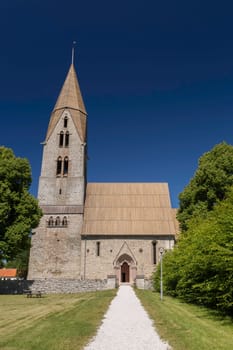 Church at Oja, Gotland, Sweden with a clear blue sky.