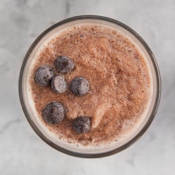 Chocolate smoothie on a white concrete background. Square cropping