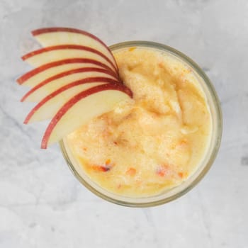 Apple smoothie on a white concrete background. Square cropping