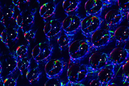 Abstract water drops are on dark blue background.