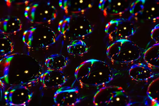 Colorful water drops are on black background.