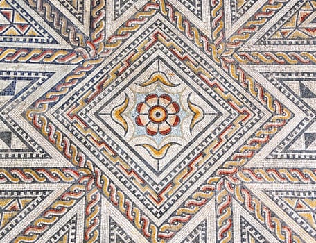 Ancient roman stone mosaic floor with geometric design