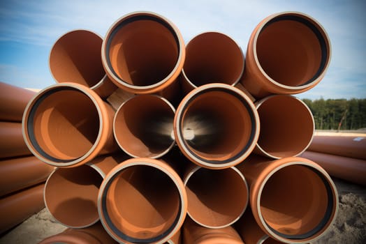 stack of pvc pipes on a construction site