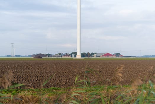 dutch farm with large windmill in front