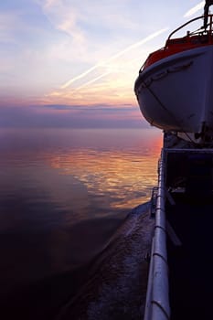 Lifeboat on a ship at sunset. Lifeboat on a pass