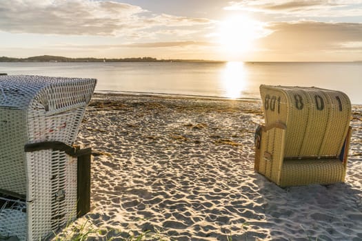 European Beach wicker chairs are placed decoratively on the beach for summer guests in the sun
