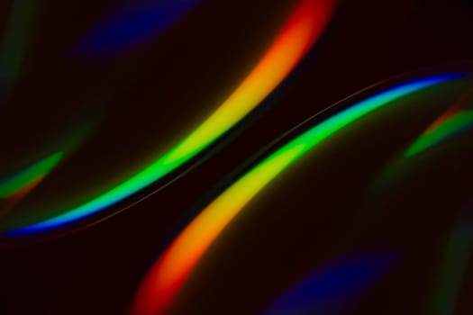 Colorful symmetrical abstract pattern on black background.