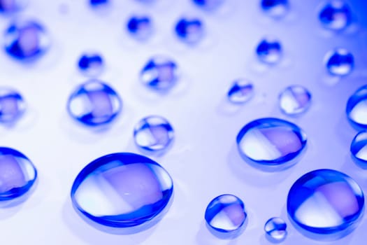 Abstract background is from blue water drops on white background.