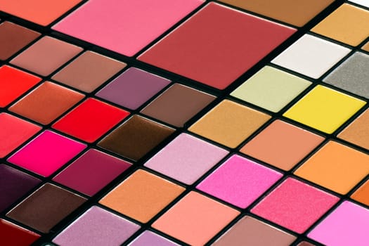 Colorful make-up palette with lipsticks and eye shadows.