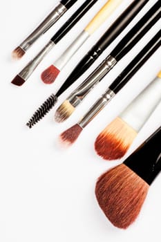 Different make up brushes are on white background.