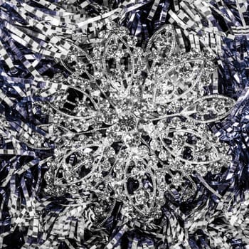 Silver jewelry is on abstract texture background.