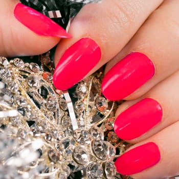 Macro photo about female fingers with pink nails, manicure.