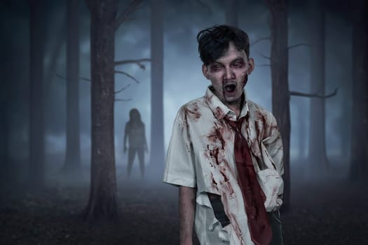 Scary two asian zombies with wounded face on the forest at night