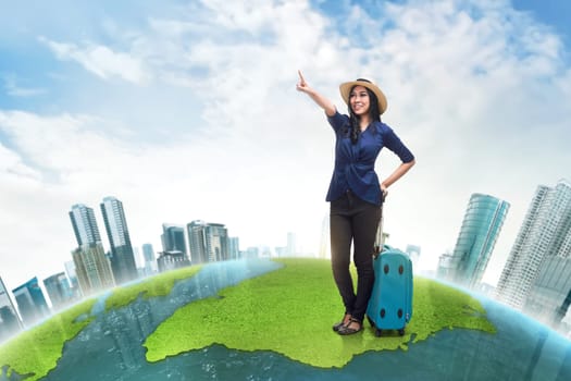 Happy asian woman tourist wearing hat looking something against futuristic background