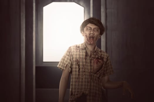 Creepy asian zombie male with wounded face walking on the dark room
