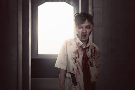 Scary asian zombie man in clothes standing on the dark room