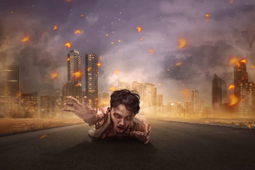 Aggressive asian bloody zombie man crawling from burning city