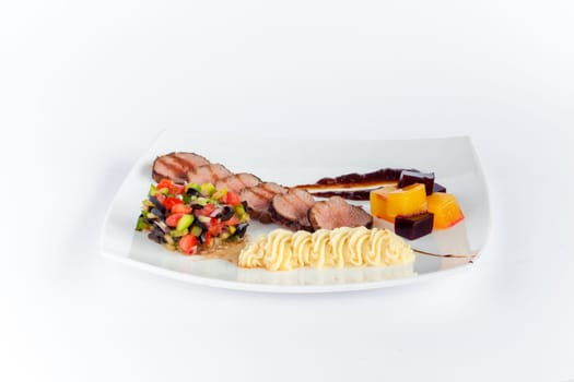The rack of saucy barbecue pork served on white plate in restaurant