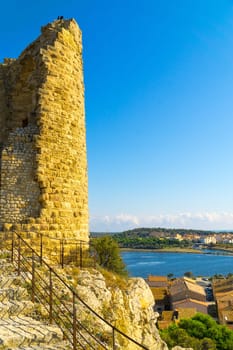 View from the historic castle ruin "Tour Barberousse"" down to the medieval village of Gruissan and the pond ""Etang de Gruissan"" on the Mediterranean coast in southern France."