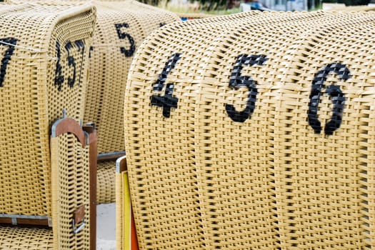 European Beach wicker chairs are placed decoratively on the beach for summer guests in the sun
