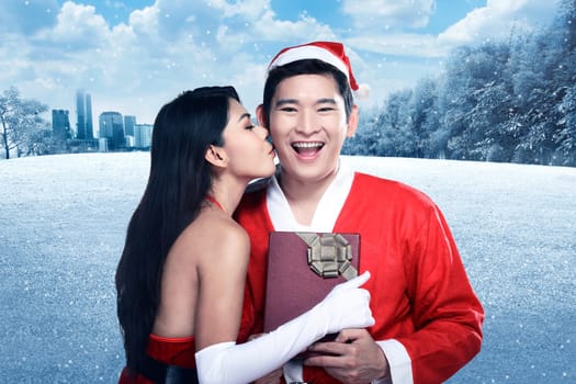 Santa woman give kiss to her lover. Christmas concept