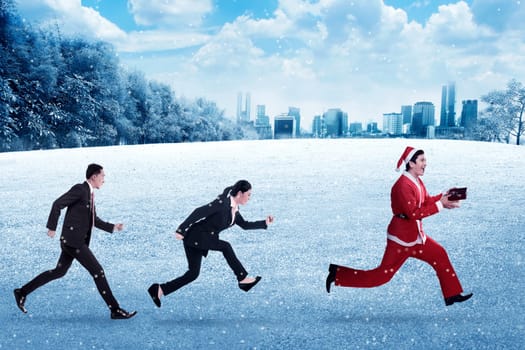 Business people chasing santa claus. Christmas bonus concept