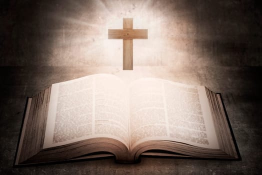 Open holy bible with wooden cross in the middle. Christian concept