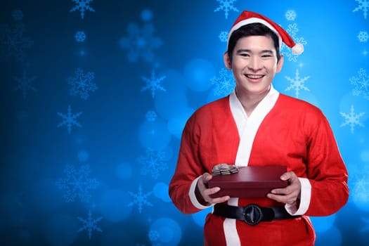 Asian man wearing santa claus costume holding gift box. Christmas concept