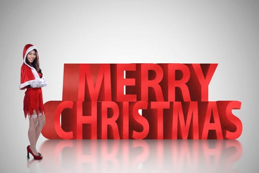 Pretty asian woman standing with merry christmas 3D text. Christmas concept