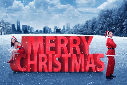 Asian couple in santa claus costume posing on merry christmas text. Christmas couple concept