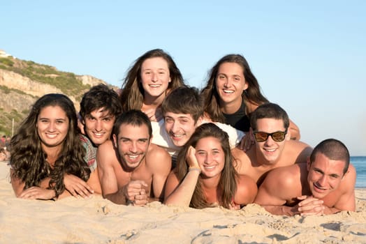 Group of happy teenage friends at the beach
