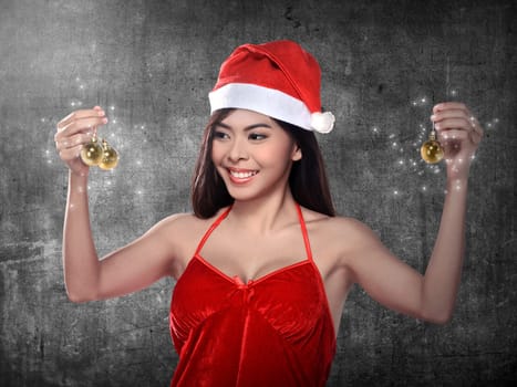 Pretty woman in santa claus costume holding christmas ball. Merry christmas concept