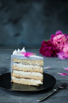 Slice of Birthday Cake with a flowers on a blue background.