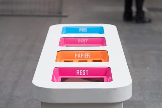 waste bin in several colors at the antwerp central station
