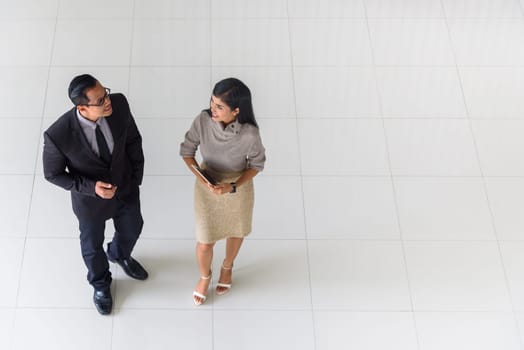 Top view, Asian business people, man and woman, talking about ideas, copy space, selective focus
