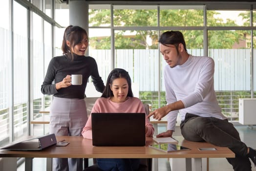 young asian businessman working with team in startup office