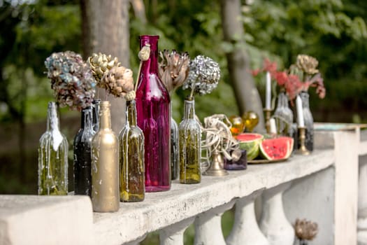 Burning candle in the vintage black bottle. Wedding decor
