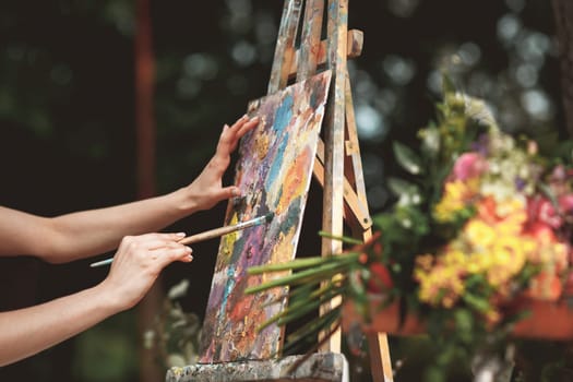 The artist's hand close-up on the background of the picture