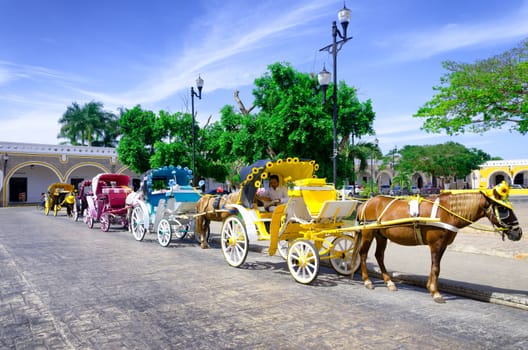 IZAMAL, MEXICO - FEBRUARY 19: Tourist carriages on the plaza in Izamal, Mexico on February 19, 2017