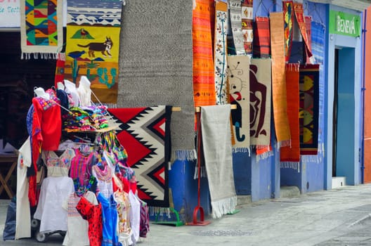 OAXACA, MEXICO - MARCH 4: Colorful rugs and clothes for sale in Oaxaca, Mexico on March 4, 2017