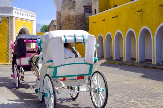 View of tourist carriages in street in Izamal, Mexico.