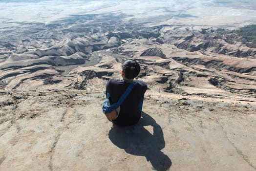 Man on top of Layer Volcanic ash as sand ground of Mount Bromo volcano (Gunung Bromo) at Bromo Tengger Semeru National Park, East Java, Indonesia.