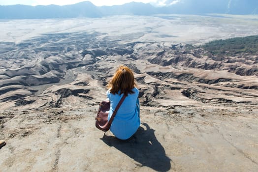 Woman on top of Layer Volcanic ash as sand ground of Mount Bromo volcano (Gunung Bromo) at Bromo Tengger Semeru National Park, East Java, Indonesia.