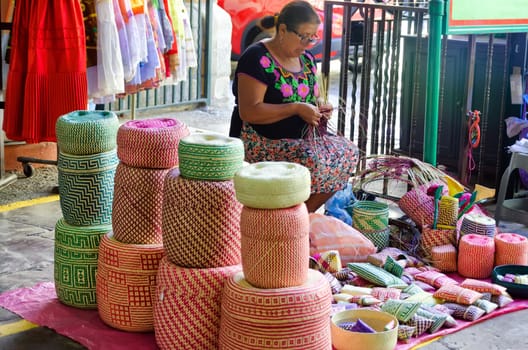 OAXACA, MEXICO - MARCH 5: Woman makes traditional baskets for sale at local market in Oaxaca, Mexico on March 5, 2017