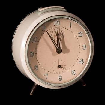 Old alarm clock five to twelve