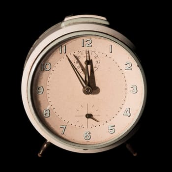 Old alarm clock five to twelve