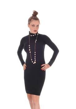 A beautiful young Caucasian woman in a black dress and necklace.standing and looking unhappy, isolated for white background.