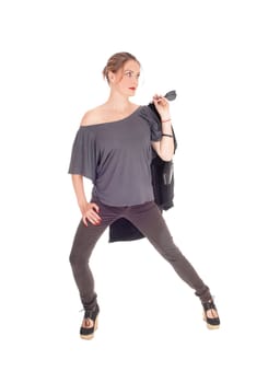 A slim young woman in jeans with her jacket in her hand is.ready for a walk, isolated for white background.