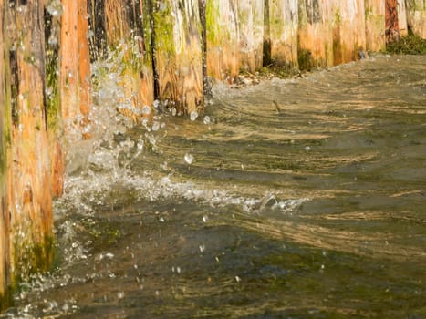 Close-up of water hitting a wooden shore fortification on Lake Caldaro.