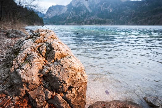 Rough rugged rock on the banks of the Alpsee in the Schwangau near Neuschwanstein Castle in autumn.
